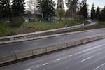 A camp of unhoused people is seen along an empty stretch of I-5 in North Portland. As Portland residents have sheltered in place, there have been fewer extra resources available for the city’s unhoused community.