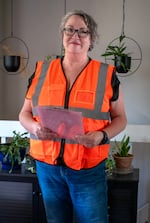 Tea Godfrey in an orange safety vest with a clipboard in her hand