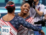 Simone Biles was all smiles with teammate Jordan Chiles after finishing her routine on the uneven bars during the women's gymnastics team final at the Olympic Games in Paris. 