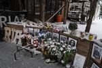 A memorial is set up among the remains of Ria Pizzeria, a beloved restaurant in Kramatorsk that was hit by a Russian strike in June 2023, killing staff and customers.