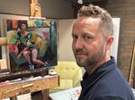 Ashland-based artist Gabriel Lipper stands next to his art piece. Lipper's influences range from French and Italian Renaissance painting to contemporary graphic novels and modern hip hop.