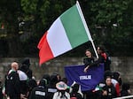 Italy athletes aboard a boat in the floating parade on the river Seine during the Opening Ceremony of the Olympic Games Paris 2024 on July 26.