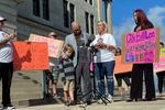 Carolyn Miller (center right) speaks at a news conference called by friends and family of Tennessee death row inmate Gary Sutton on Oct. 6, outside the Tennessee State Capitol in Nashville. Rev. Jeff Hood stands next to Miller while hugging his son.