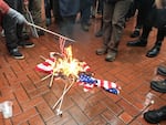 A growing crowd of protesters gathers at Pioneer Courthouse Square in Portland on Jan. 20, 2017, as some participants set American flags on fire. 