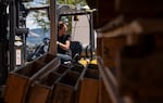 Phelps Creek winemaker Lauren O’Brien moves barrels at Phelps Creek Winery in Hood River, Ore., on July 14, 2026.
