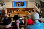 Portland City Councilor Angelita Morillo receives silent applause from audience members during a Portland City Council meeting Nov. 12, 2025. The council held a vote on Morillo's proposal to divert funds from the city’s homeless camp removal team.