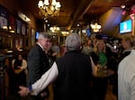 Portland mayoral candidate Rene Gonzalez, left, greets supporters at his election night party held at Kells Pub in Portland, Ore., Nov. 5, 2024.