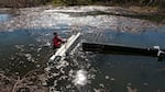 Jakob Shockey floats a pond leveler out into the middle of the beaver pond in Phoenix. The device acts like a bathtub overflow drain, preventing the pond from growing any big, no matter how high the beaver builds the dam.