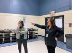 Yaquina View Elementary School principal Kristin Takano Becker, left, and Lincoln County School District Communications Coordinator Kristin Bigler inside the current Yaquina View gym. The gym currently serves as a cafeteria and gym for students at the school.