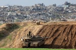 An Israeli battle tank is positioned along the border with the Gaza Strip in southern Israel on Jan. 17.