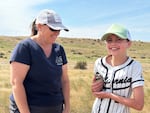 Judy Johnson, left, helps 11-year-old Gabby Chase hold a baby burrowing owl on property managed by the Confederated Tribes of the Umatilla Indian Reservation. Volunteers helped researchers band the baby owls so that the birds can be tracked throughout their lifetimes.