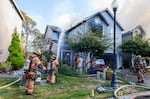 In this image provided by Portland Fire & Rescue, teams work at the scene where a small aircraft crashed into multiple townhouses in Fairview, Ore., Aug. 31, 2024, killing three people.