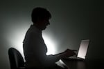 FILE - A woman types on a computer in a file photo. Oregon is teaming up with a nonprofit to provide free training to state workers on how to use generative artificial intelligence.