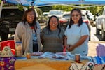 From left, Deanie Johnson, Valerie Switzler and Doris Miller, all Warm Springs tribal members, staffed a booth that shared the traditional names of fish and information on various fish storage methods. A large pickle jar filled with layers of rock salt and salmon belly illustrated one traditional storage method.