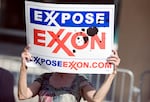 A protester holds a sign outside of the ExxonMobil annual shareholders meeting in Dallas in 2008.