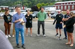 Paul Silka, left, briefs swimmers on event logistics outside the Columbia River Maritime Museum. Silka is Emergency Department medical director for Columbia Memorial Hospital, and organized the Swim Across the Columbia event as a fundraiser for the hospital. 