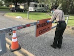 Washington State Parks area manager Audra Sims removes the "Emergency Closure" sign from the gate at Sacajawea Historical State Park, outside Pasco. The park re-opened to the public on May 5, after a nearly six-week closure.