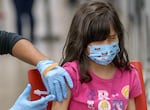 Miranda Campos, 9, closes her eyes as she receives an immunization at a catch-up vaccination clinic held at McDaniel High School in Northeast Portland on Feb. 8, 2023. 