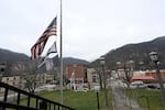 Flags fly at half-staff for West Virginia National Guard Specialist Sarah Beckstrom at the Webster County Courthouse in Webster Springs, W.Va., on Wednesday.