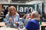 Iowa Democratic Party Chair Rita Hart (left) speaks with volunteers at the 1st Congressional District Convention in Iowa City, Iowa May 2, 2026.