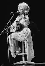 American singer Dolly Parton performs during her Tokyo concert on Monday, July 30, 1979. The popular vocalist, who won the Grammy award this year, sang 20 songs before a crowd of 1,600.