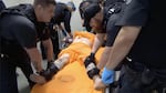 A screenshot from a video of officers at the U.S. penitentiary in Thomson, Ill., holding an incarcerated person in a four-point restraint.