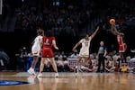 North Carolina State guard Saniya Rivers (22) shoots a 3-point shot as Texas forward Madison Booker (35) defends during the first half of an Elite Eight college basketball game in the women's NCAA Tournament, Sunday, March 31, 2024, in Portland, Ore.