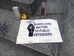 A sign outside downtown Portland's Apple Store, which has been closed since the start of nightly protests against police brutality, and where protesters have painted plywood wall coverings in murals and have left tributes to their cause.