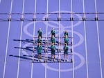 Volunteers transport the hurdles ahead of the women's heptathlon 100m hurdles event at Stade de France in Saint-Denis, north of Paris.
