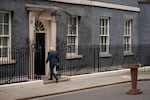 Prime Minister Boris Johnson walks back into 10 Downing St. after announcing his resignation as Conservative Party leader on Thursday.