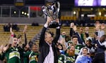 Portland Timbers owner Merritt Paulson raises the trophy after the Timbers defeated the Columbus Crew 2-1 in the MLS Cup championship soccer game Sunday, Dec. 6, 2015, in Columbus, Ohio.