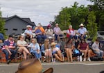 Onlookers watch the Fourth of July parade at the 90th St. Paul Rodeo. The small town of around 400 residents attracts thousands with its holiday festivities.