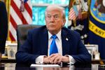 President Donald Trump listens to a reporter's question in the Oval Office of the White House, on Friday.