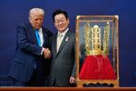 President Donald Trump shakes hands with South Korean President Lee Jae Myung as he receives a gift of a gold crown and an award of the Grand Order of Mugunghwa, not seen, during a high honor ceremony at the Gyeongju National Museum in Gyeongju, South Korea, Oct. 29, 2025.