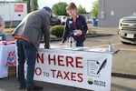 Campaign supporters at a primary election watch party for Rep. Ed Diehl, a Republican gubernatorial candidate from Scio, sign his latest petition attempt to undo parts of a law Democrats passed in the 2026 legislative session that disconnected the state from some of the tax cuts passed under Trump’s 2025 summer tax and spending law.