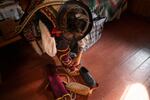 Volodymyr Sinitovych ties up traditional shoes that are part of his costume for the Hutsul theater.