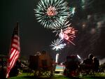 Spectators watch as fireworks explode overhead during the Fourth of July celebration at Pioneer Park, on July 4, 2013, in Prescott, Ariz.