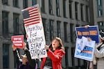 Protesters hold signs in solidarity at a rally in support of federal workers at the Office of Personnel Management in Washington, D.C., on March 4.