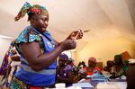 A nurse prepares to administer a newly approved malaria vaccine, RTS,S, to an infant at the health center in Datcheka, Cameroon, on Jan. 22. Cameroon is the first country in the vaccine campaign. Plans are to introduce the vaccine in 20 additional countries by 2025.