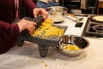 A summit attendee grinds corn for fresh tortillas during a teaching kitchen class that took place during the Indigenous Food Summit at Portland State University on Sept. 9, 2026.