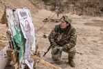 Liudmyla, 42, checks her shots at the shooting range in Kyiv region, Ukraine, on Oct. 12, 2024.