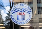 The Social Security Administration's logo appears on a window of a Social Security Administration office in Washington, D.C., on March 26.