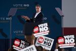 Supporters hold up signs as California Gov. Gavin Newsom speaks at a rally ahead of the California gubernatorial recall election Monday, Sept. 13, 2021, in Long Beach, Calif.