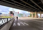 A pedestrian walks in the middle of the sidewalk