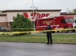 Police continue the investigation at the Tops supermarket May 18 in the Cold Spring neighborhood of Buffalo, N.Y. A gunman opened fire at the store on Saturday, killing 10 people and wounding three others. Police say it's being investigated as a racially motivated hate crime.
