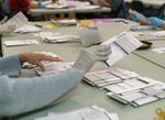 At the Clackamas County Elections office, ballots are being opened, inspected and tallied, in preparation to go through a scanning machine, May 18, 2022. A printing error on Clackamas County primary election ballots has led to turmoil that will likely take weeks to solve.