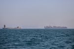 A container ship, right, and a cargo vessel are seen in the Strait of Hormuz off Bandar Abbas, Iran, Wednesday, June 17, 2026.