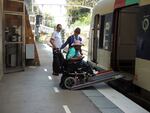 Ndieme Lame, a 57-year-old volunteer for the Paris 2024 Olympic and Paralympic Games, negotiates a ramp to board an RER train with the help of railway staff on Wednesday during the 2024 Summer Olympics in Paris, France. 