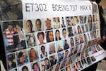 Relatives of victims hold a placard with photos of victims of the Ethiopian Airlines Flight 302 crash in March 2019, prior to a hearing in Fort Worth, Texas, in January 2023.