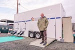 Kenny LaPoint, executive director of Mid-Columbia Community Action Council, stands outside a restroom and shower trailer at a homeless shelter facility in The Dalles on December 13, 2022. Mid-Columbia-Community Action Council is a nonprofit organization that operates the shelter and provides other services to people experiencing homelessness in Wasco, Hood River and Sherman Counties.
